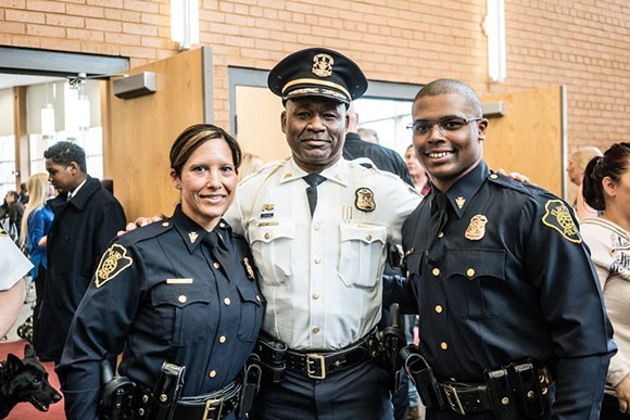 Maria and Dion Reed with Chief Johnson at the swearing in. - CITY OF FLINT POLICE DEPARTMENT ON FACEBOOK