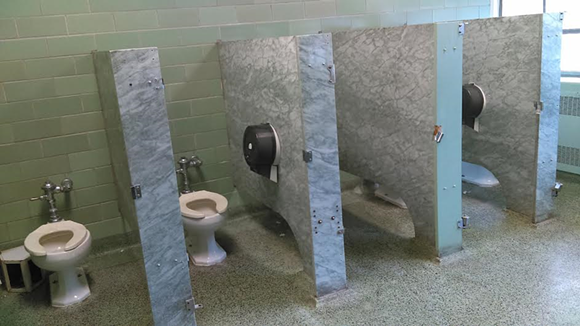 Detroit Institute of Technology bathroom stalls without doors before renovation. - photo credit: National Network of Arab American Communities