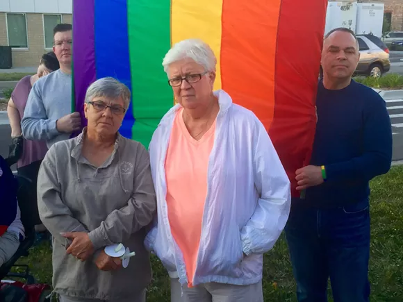 Rose O'Day, 62, left, with wife Kathy Huebener, 71, at a Sunday vigil at Ferndale City Hall for mass shooting victims in Orlando. A couple for 25 years, the Warren women married in October after same-sex marriage became legal in Michigan. - Photo by Dustin Blitchok.