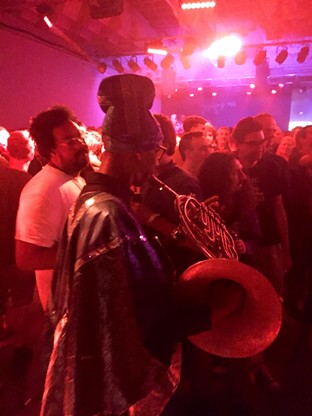 A member of the Arkestra weaves through the audience during the concert at El Club. Photo by Dustin Blitchok.