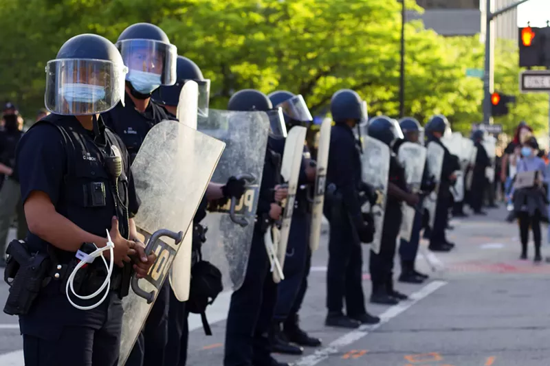 Detroit police clad in riot gear form a barricade outside Public Safety Headquarters. - Steve Neavling