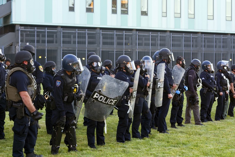 Detroit police lined up with helmets and shields before enforcing the curfew Sunday. - Steve Neavling