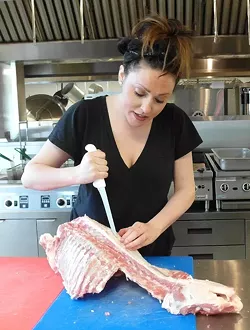 Chef Kate Williams breaking down a lamb at Eastern Market. - Photo by Serena Maria Daniels