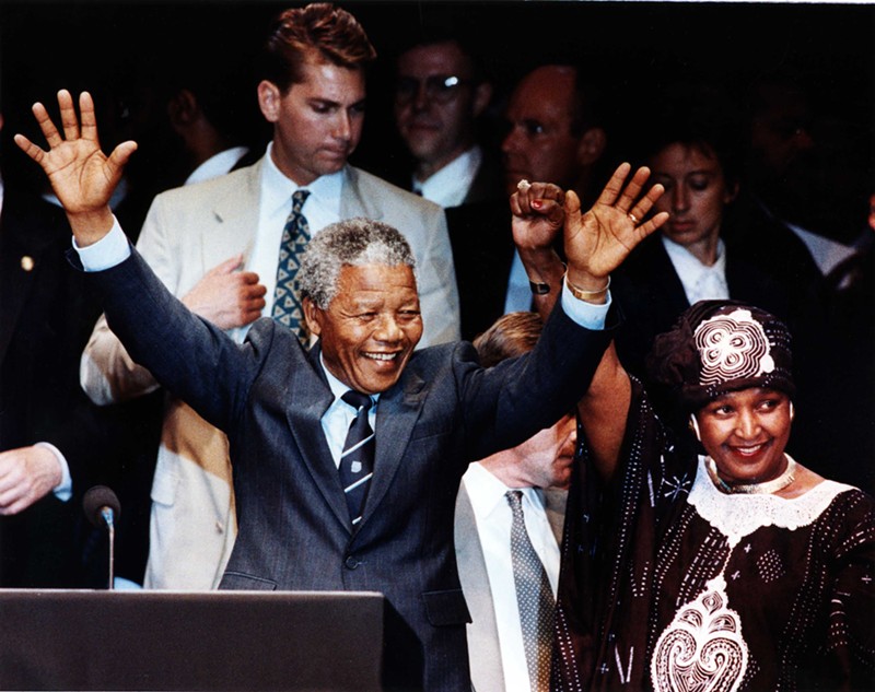 Amid impassioned cries of “Amandla!” and “Viva Mandela!” Nelson and Winnie Mandela wave to a crowd of more than 49,000 people at Tiger Stadium June 28, 1990. - D. Weiss/Walter Reuther Library