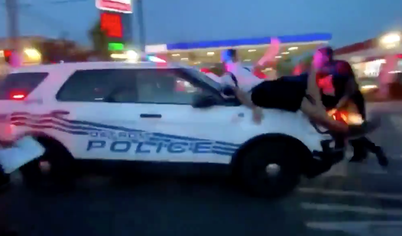 Screen grab from a video of a police car plowing through a group of protesters. - Ethan Ketner