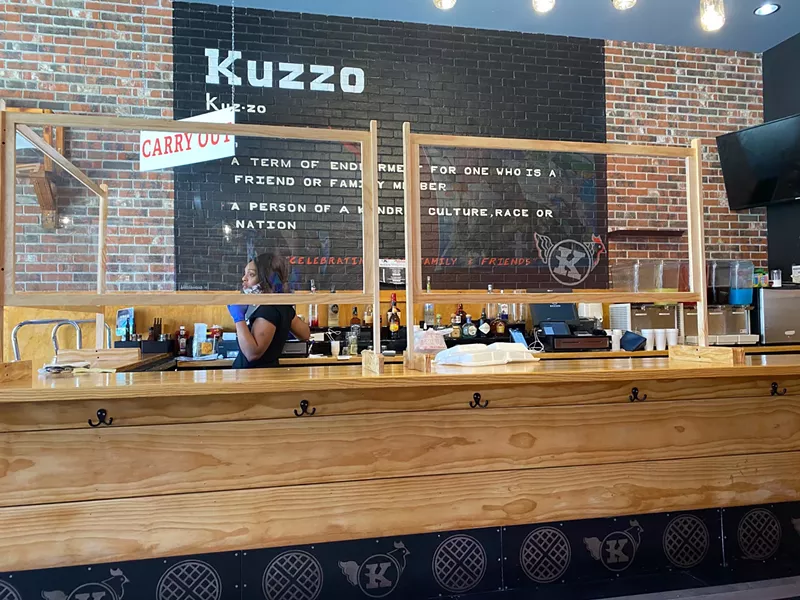 The coronavirus crisis came to Michigan just as Detroit's Kuzzo's Chicken & Waffles returned from a hiatus. The restaurant was forced to quickly adapt, installing plexiglass panes and pivoting to takeout service. - DAVID RUDOLPH PR