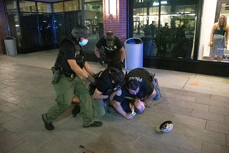 Detroit police tackle a protester early Sunday morning. - Adam J. Dewey