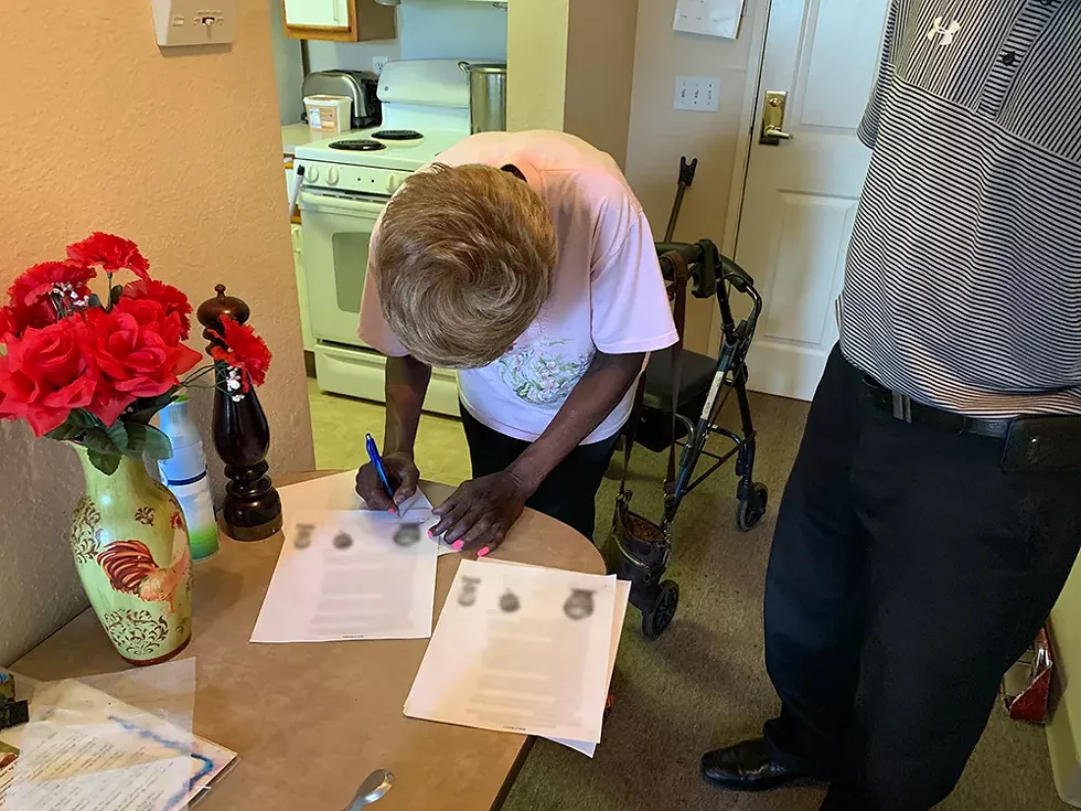 Barbara Hill signs an affidavit swearing that Ray Gray is in fact an innocent man. - Photo by Bill Proctor