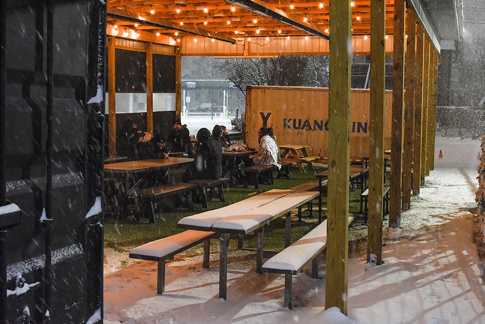 Guests drink beers under Batch Brewing Co.'s "Fauci Fieldhouse" outdoor pavilion. The company has decided not to reopen for indoor dining until more people get vaccinated. - Kelley O'Neill