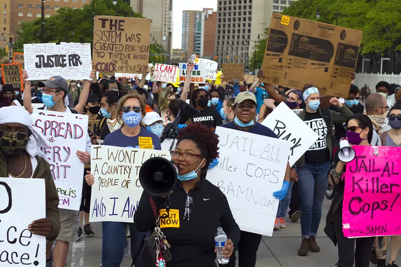 Nakia Wallace, in center with a megaphone, marches with protesters in June 2020. - Steve Neavling