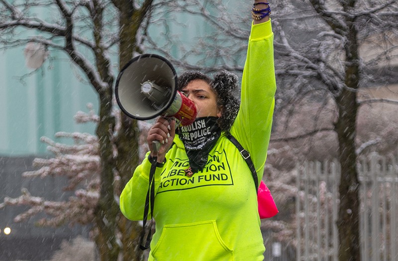 A person wears a mask that says "Abolish the Police" at a gathering of Detroiters reacting to the news that former Minneapolis police officer Derek Chauvin was found guilty on all counts for the murder of George Floyd. - RUSTY YOUNG