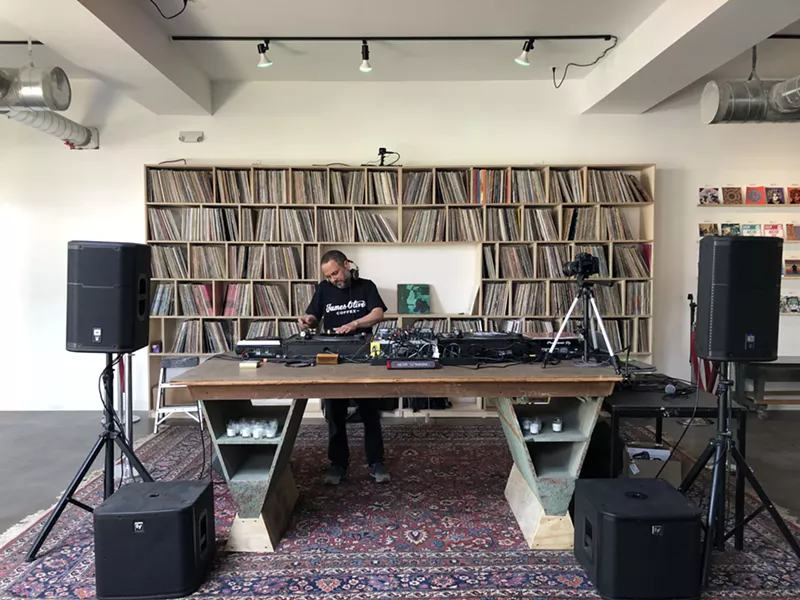 Shelves of vinyl records behind a DJ booth come from 1xRun co-owner Jesse Cory's personal collection. - Lee DeVito