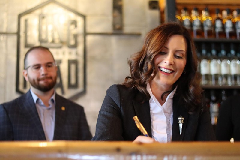 Gov. Whitmer signing bills, which will make it easier for distillers and retailers to distribute and sell mixed spirit drinks. - STATE OF MICHIGAN