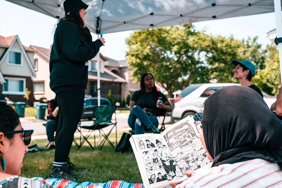 Deena Mohamed talks to a small crowd of comic enthusiasts gathered at Dearborn's Green Brain Comics. - Courtesy of the Arab American National Museum