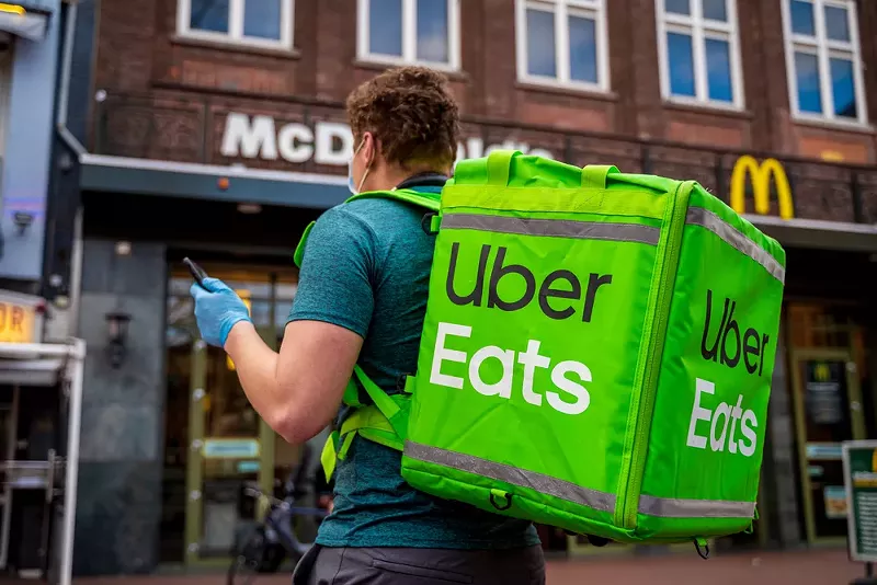 An Uber Eats food delivery man. - Riku Mannisto / Shutterstock.com