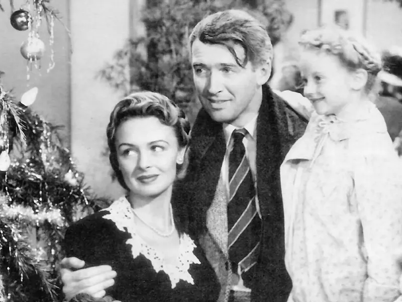 Jimmy Stewart, Donna Reed, and Karolyn Grimes in It's a Wonderful Life. - Public domain