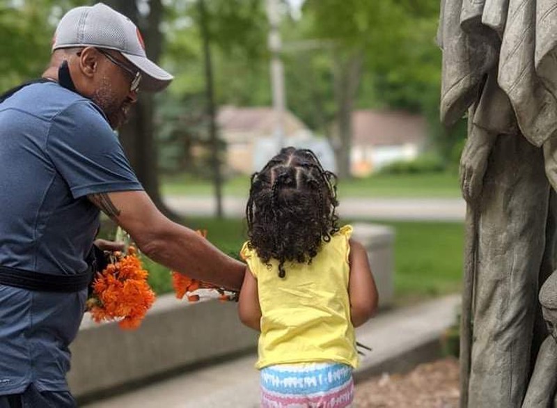 Plaintiff Tony Miller with his daughter at a statue in the Garden of Honor in Allendale Township, where he wanted to inscribe a brick with the phrase "Black Lives Matter” or “Indigenous Lives Matter.” - CIVIL RIGHTS LITIGATION INITIATIVE