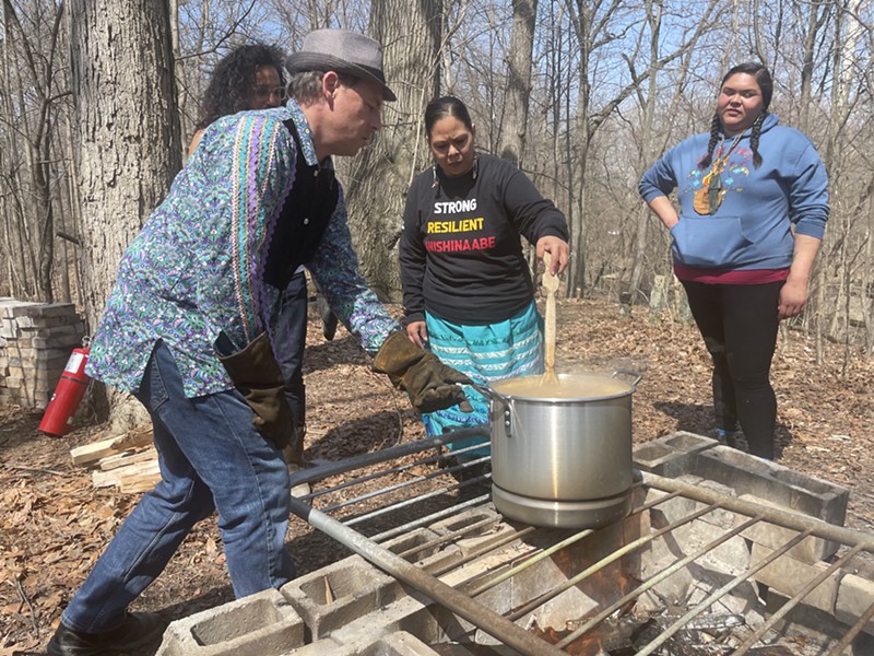 Community members boil and stir the maple syrup. - Randiah Camille Green