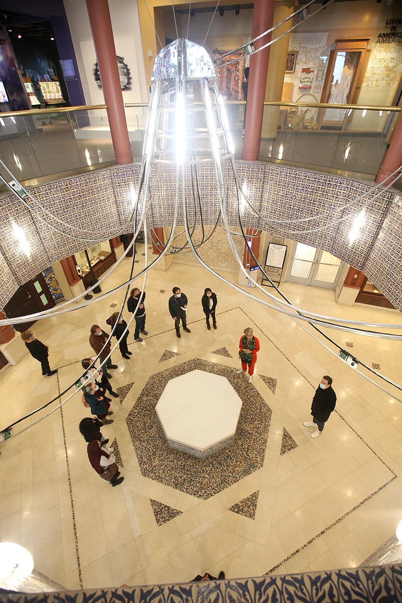 Artist Alia Ali gives a tour of her new installation “al-Falaq,” which fills the atrium at the Arab American National Museum in Dearborn. - Courtesy of the Arab American National Museum