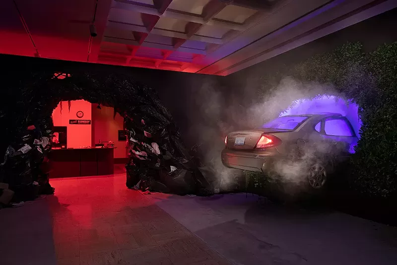 Flint artist Tune Olaniran's multi-media Made a Universe exhibit at Cranbrook Art Museum includes a broken-down car lodged into the wall. - Cranbrook Art Museum and PD Rearick