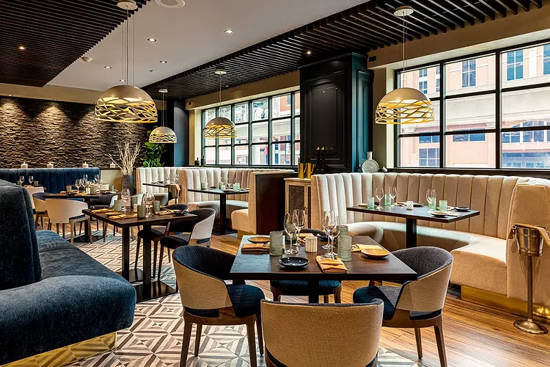 Symposia is located in Greektown’s Atheneum Suite Hotel and Conference Center. - Gerard + Belevender