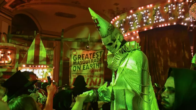 Zombo the Clown in front of a sign that reads "The Greatest Masquerade on Earth." - Mike Pfeiffer