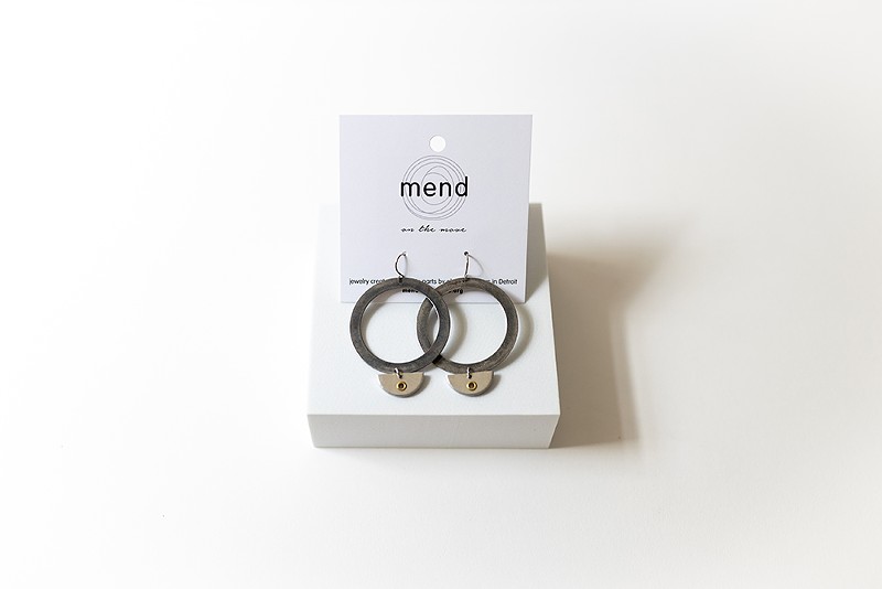 A pair of earrings made from recycled auto parts by Mend on the Move. - Hannah Steppey