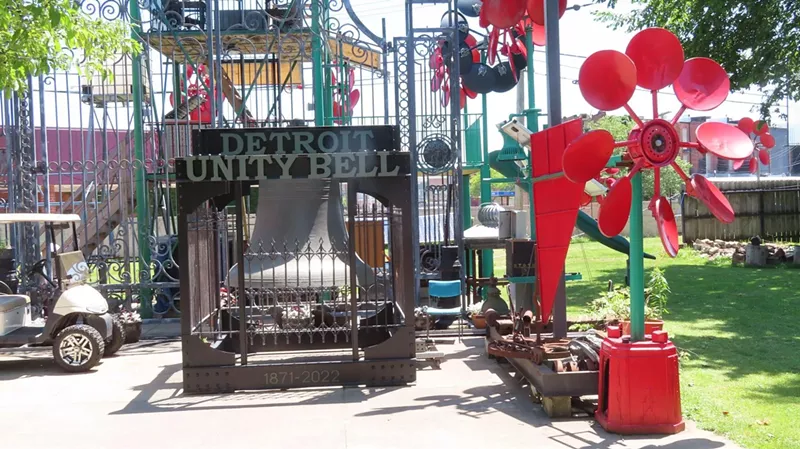 The Detroit Unity Bell among a forest of Detroit Windmills, at C.A.N. Art Handworks on Wilkins Street, prior to installation at Eastern Market in September 2022. - Photo by author