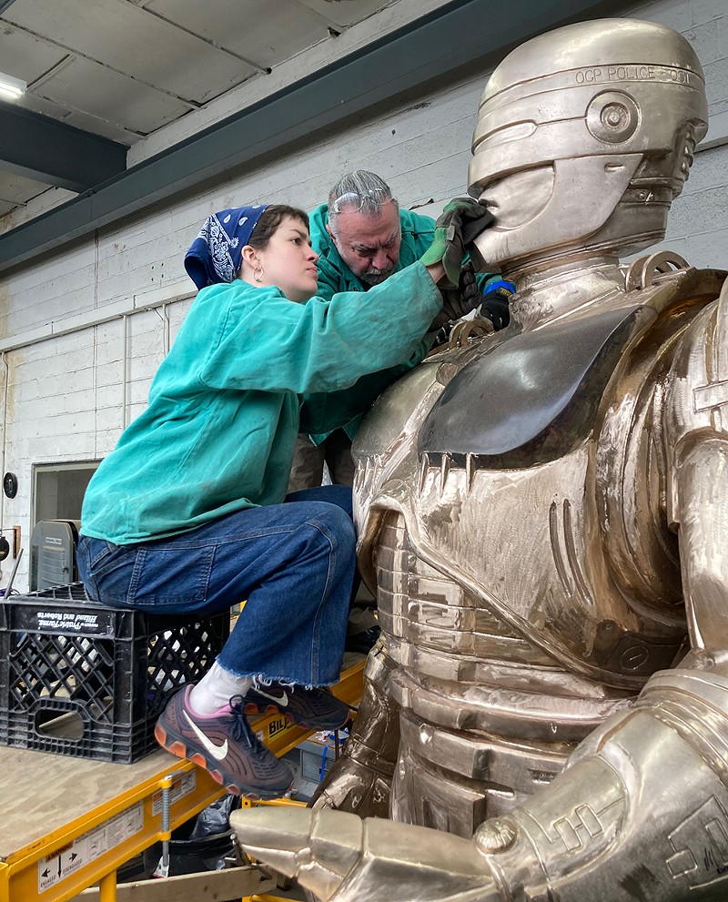 Venus Bronze Works' Giorgio Gikas, center, puts the finishing touches on Detroit's long-awaited RoboCop statue, with help from assistant Nadine Chronopoulos. Now the statue just needs a home. - Jay Jurma