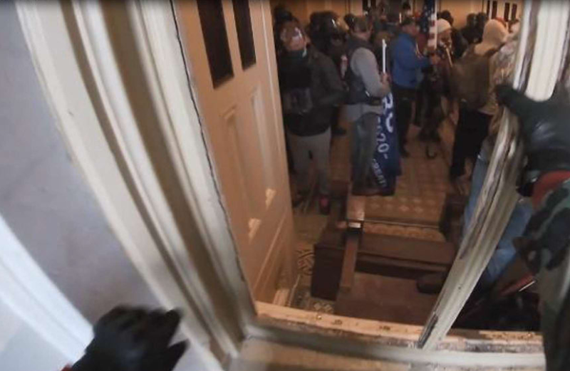 Screenshot of GoPro video of Anthony Michael Puma crawling through a broken window at the U.S. Capitol on Jan. 6. - FBI