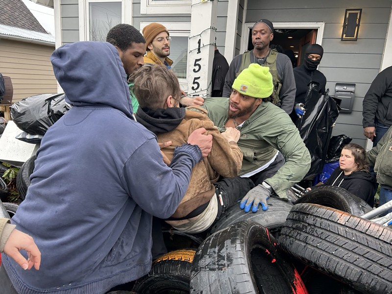 Bailiffs and movers forcibly remove protesters who were protecting Taura Brown from being evicted in Detroit. - Steve Neavling