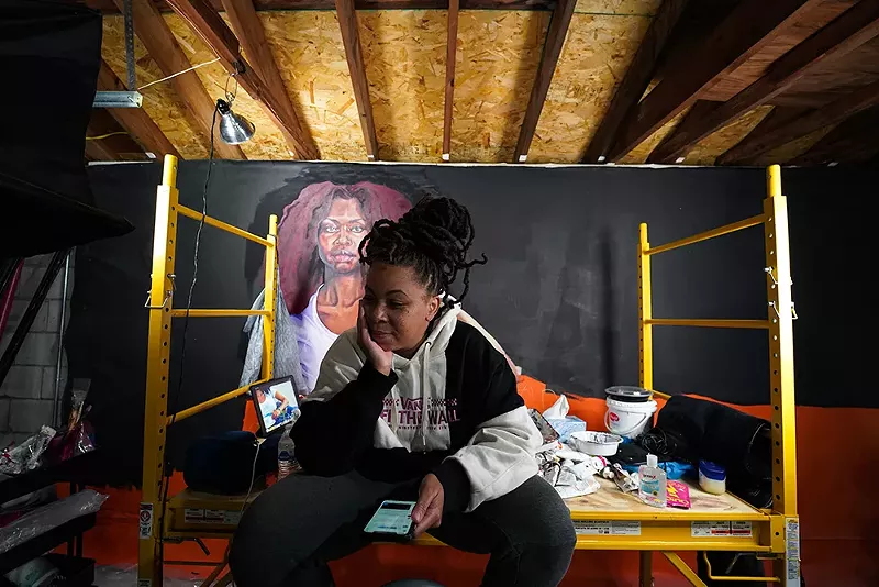 Sydney G. James takes a break from working on her painting “Serving Tee.” - Lamar Landers