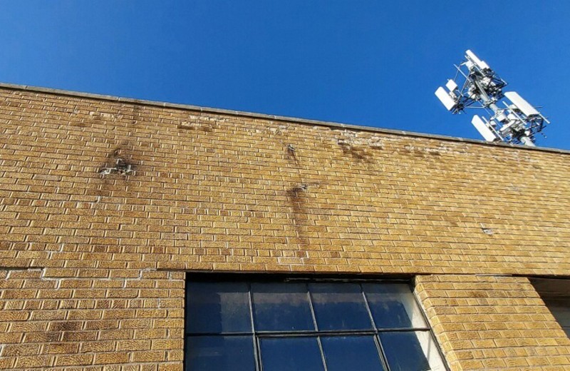 City workers removed Giroux’s sign, ripping off bricks on the facade and puncturing a hole in his roof. - Patrick Giroux