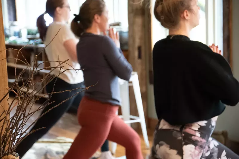 Cannabis retreat guests relax with yoga at a getaway in Clymer, New York. - Caitlyn Thomas