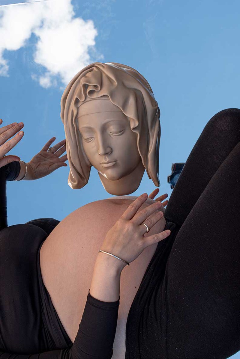 “Pregnant torso with head of the Pietà against mirror and sky,” 2021 - By Kylie Lockwood - Archival inkjet print, 11 1/8" x 16 1/2". Courtesy of the artist and Simone DeSousa Gallery. -  -  - Kylie Lockwood (b. 1983, Detroit) is an interdisciplinary artist whose work reconciles the experience of living in a female body with the Western history of sculpture.