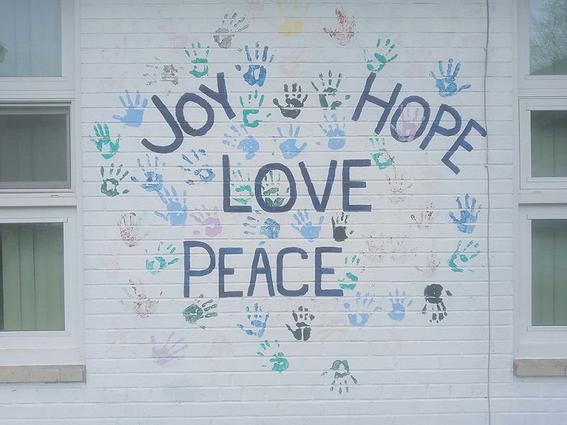 Hopeful mural art painted on one of the pantry’s exterior walls. - Eleanore Catolico