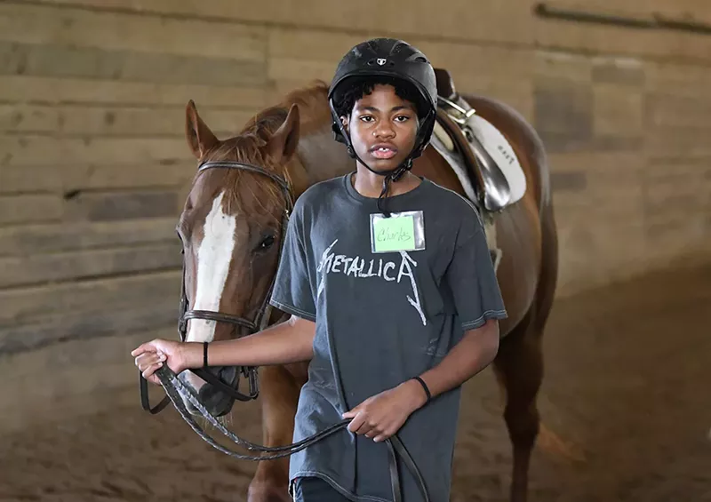 Detroit Horse Power program student Charles Johnson, 13, walks his horse around the training ring at Willowbrooke Farm in Plymouth. - Lon Horwedel, Courtesy The Kresge Foundation