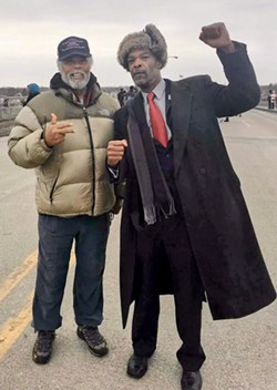 Human rights activist Sam Riddle (left) with Flint City Councilman Eric Mays. - Courtesy of Sam Riddle