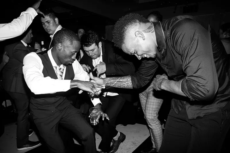 One photo of Okwara’s on display at Periodicals, featuring NFL player Marvin Jones dancing at former NFL player Devon Kennard’s wedding. - Romeo Okwara