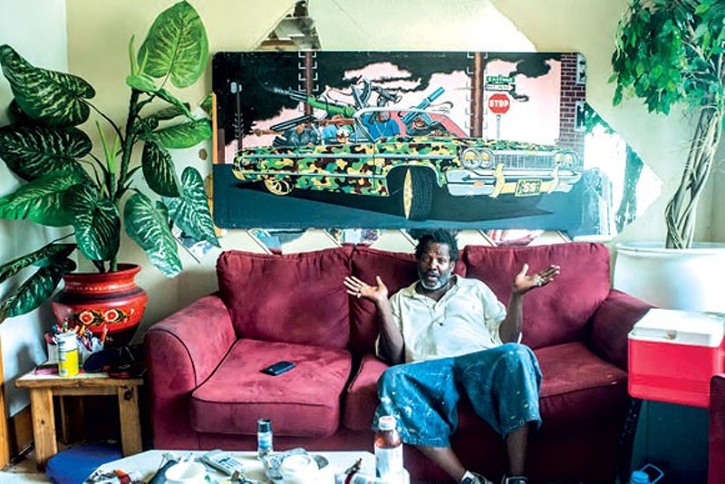 Detroit artist “Bird,” photographed at his home and studio. Vergara's book has Bird asking, "How come people from all over the world are coming to Detroit and making it and people from here can't get shit?" - Courtesy Camilo Jose Vergara
