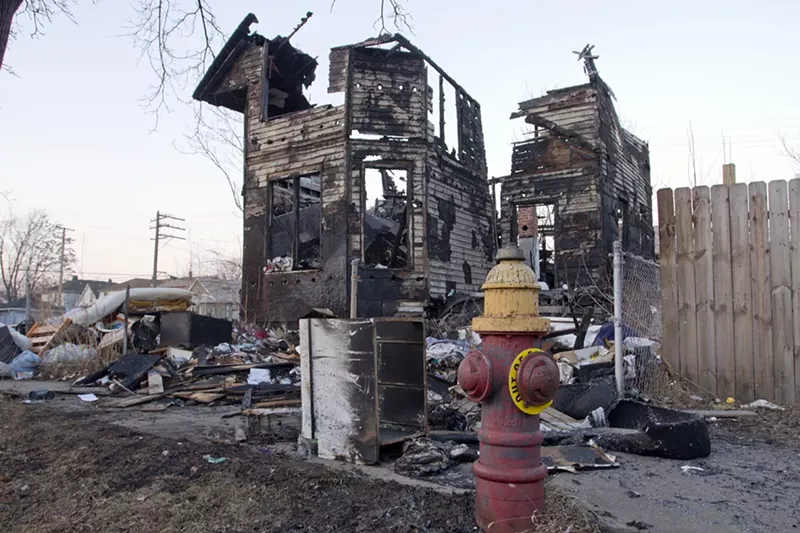 A broken hydrant outside of a burned home in Detroit. - Steve Neavling