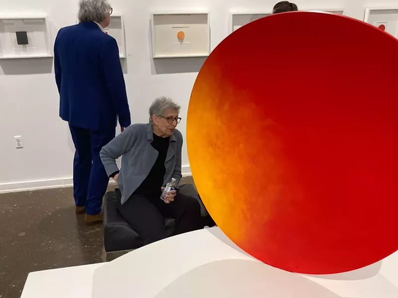 Lois Teicher sits next to her work “Solar Flare.” - Joe Lapointe