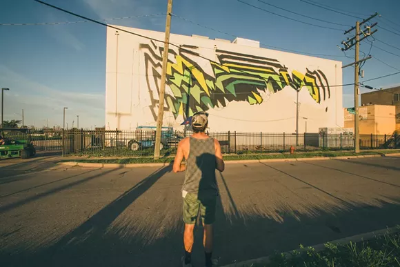 German-based artist 1010 surveys his Eastern Market mural, created in 2016. - Emad Rashidi