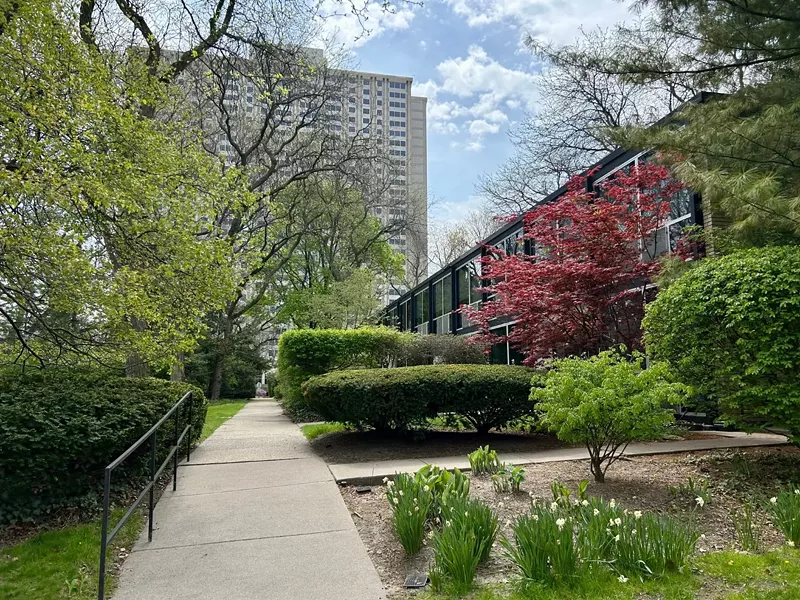Residents of the 1300 Lafayette high-rise (background) want to use steam heat that would impact the Historic Lafayette Park townhouses (right). - Steve Neavling