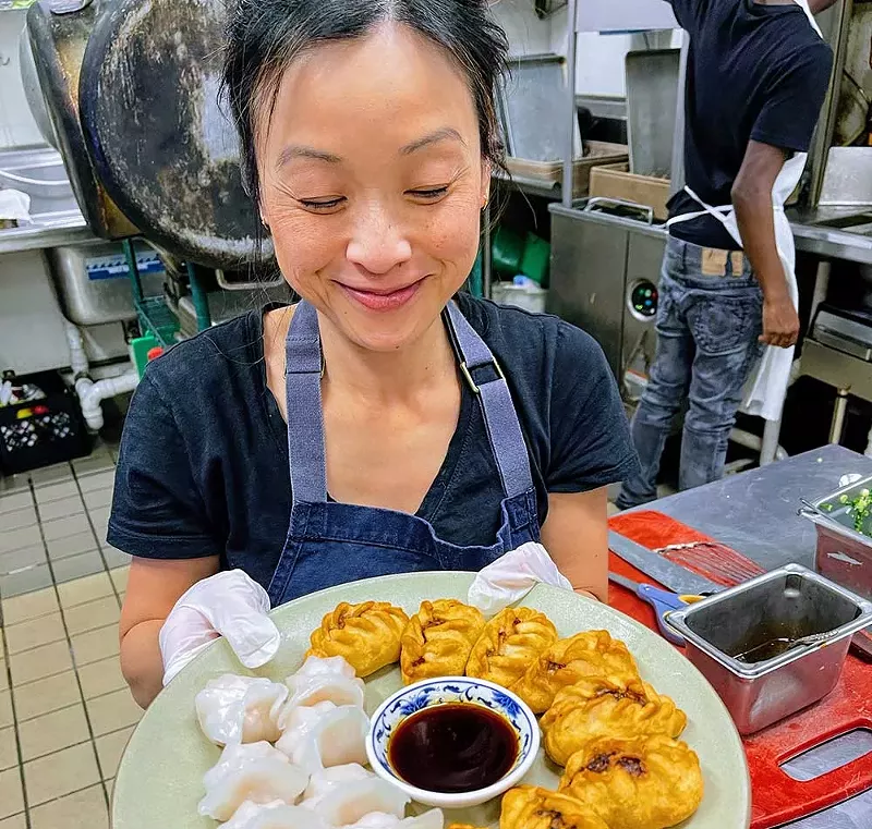 Mythy Huynh holds a tray of hand rolled dumplings during a popup service at Miss Kim in Ann Arbor. - Courtesy photo