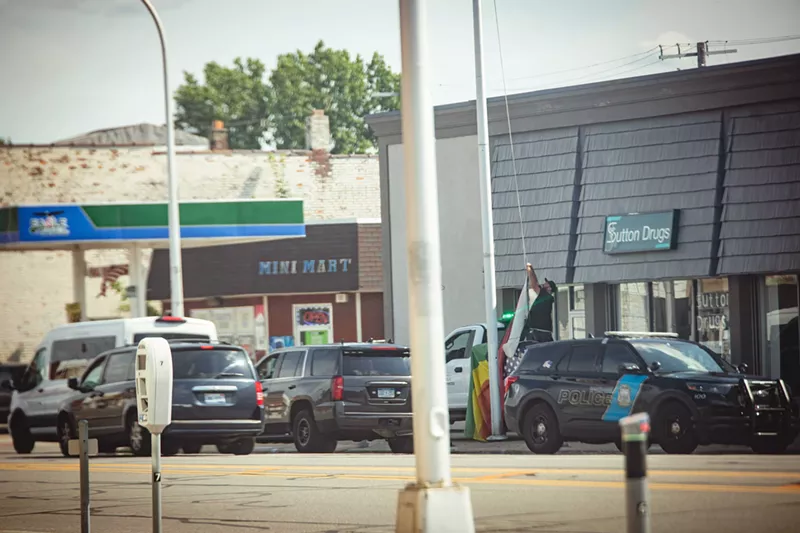 Police remove an LGBTQ+ Pride flag in Hamtramck. - Viola Klocko