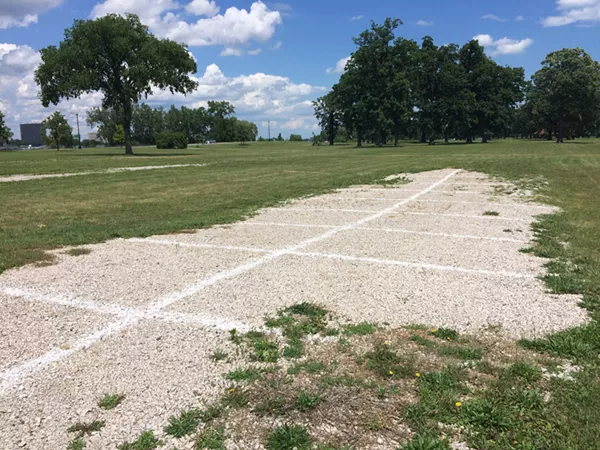 Race organizer Roger Penske's team previously threw down gravel in spots that its vehicles tore up, thus turning parts of the park into permanent parking lots. - Photo by Tom Perkins