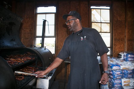 Pearson at work in the smokehouse. - TOM PERKINS