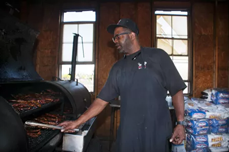 Pearson at work in the smokehouse. - Tom Perkins