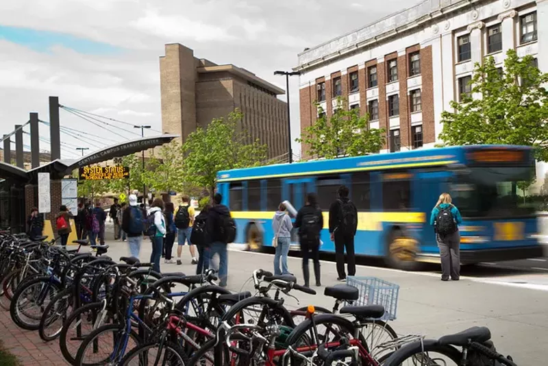 Commuters wait at the Central Campus Transit Center for the next bus - Flickr